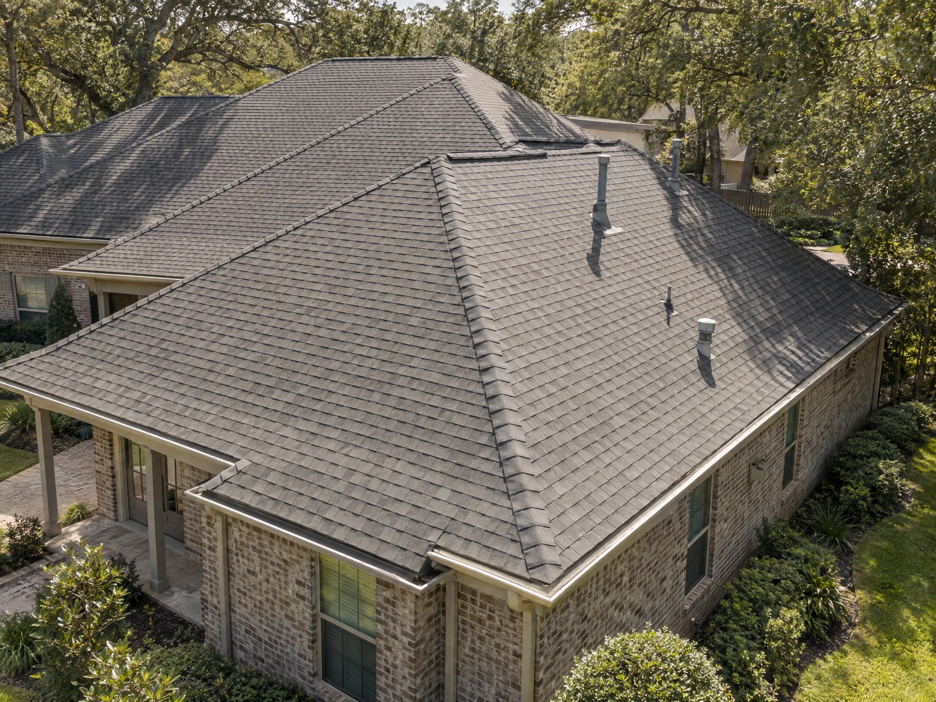 Illustrative aerial view of roof shingles, roof planes and gutters on a Southern residential home