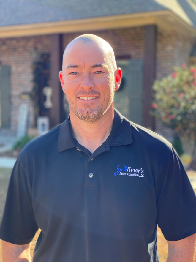 Kelly Olivier, the owner and inspector, wearing his original Olivier’s company polo